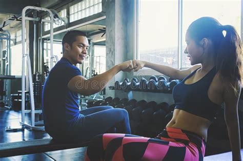 Fitness Man And Woman Giving Each Other A High Five After The Training