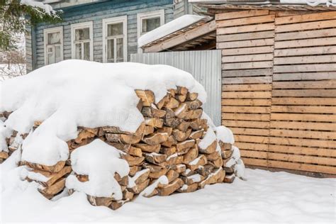 A Pile Of Firewood Under The Snow On A Frosty Day Stock Photo Image