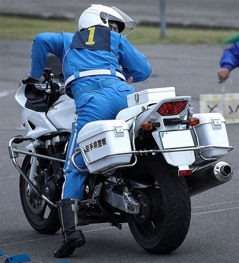 A Man Riding On The Back Of A White Motorcycle