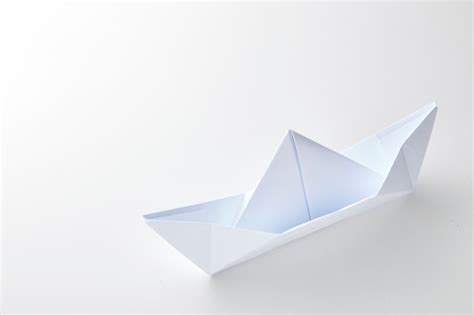 Premium Photo | Origami paper ship on white