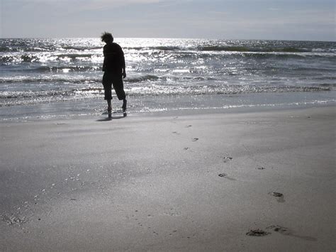 Figure Walking Along Sandy Beach Free Stock Photo Freeimages