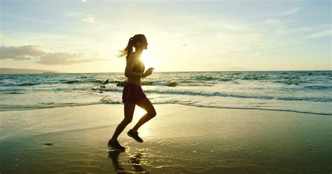 Young Woman Running on Beach 1282902 Stock Video at Vecteezy