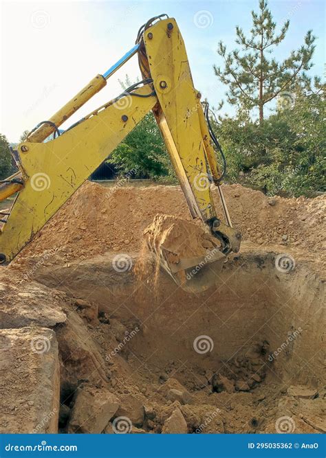 Digging The Pit Foundation A Hole With Excavator At The Construction