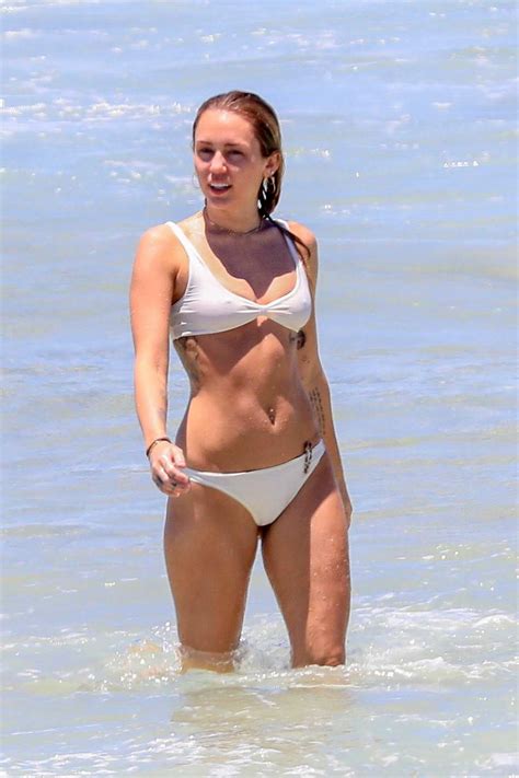 miley cyrus hits the ocean in a white bikini with liam hemsworth in ...