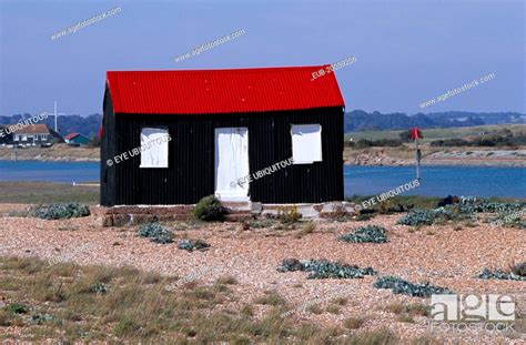 Rye Harbour Red And Black Corrugated Hut With White Doors Built On The