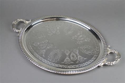 An Oval Silver Plated Handled Tray With Chased St May Denhams