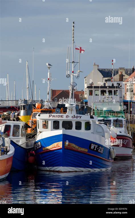 Small Colourful Fishing Boats Or Vessels Are Moored Side By Side In