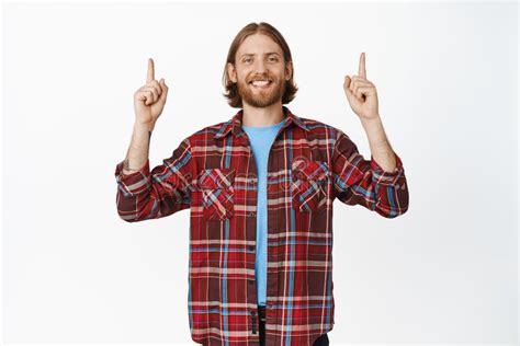 Smiling Handsome Blond Guy With Beard And White Teeth Pointing Fingers