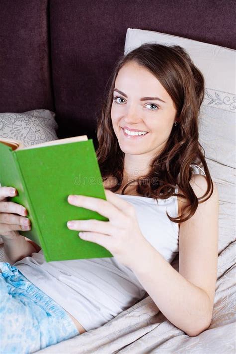 Woman Lying In Bed While Reading A Book Stock Image Image Of House