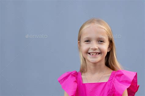 Candid Portrait Of Cute Little Caucasians Blue Eyed Girl With Blonde