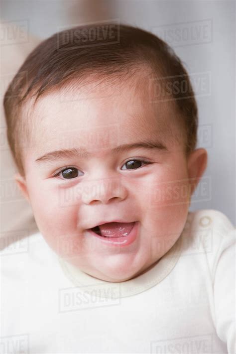 Hispanic baby boy smiling - Stock Photo - Dissolve