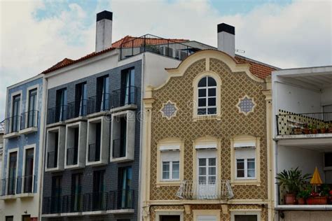 Tiled Facades Of Colourful Buildings With Windows And Balconies Outside