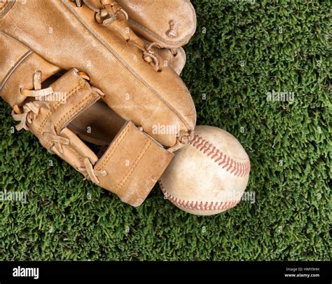 Flat View Of Old Baseball Mitt And Used Ball And On Grass Surface Stock