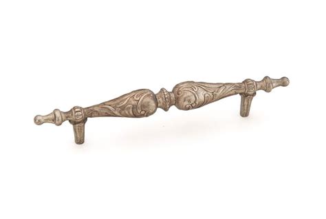 An Old Fashioned Metal Handle On A White Background