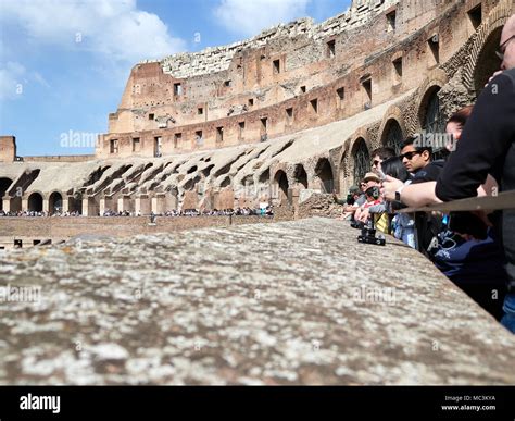 Low angle view of tourists inside of the Colosseum during the day with ...