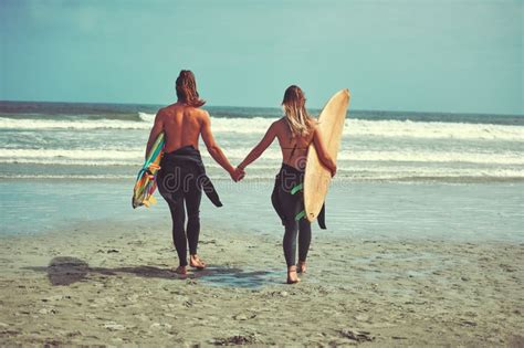 Salt Sea And You And Me A Young Couple Walking On The Beach With Their