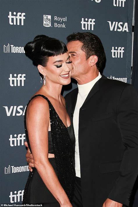 Katy Perry gets a kiss from fiancé Orlando Bloom after making X rated confession about their sex