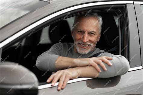 Premium Photo Confident Portrait Of A Senior Man A New Car Owner Sitting On Drivers Seat