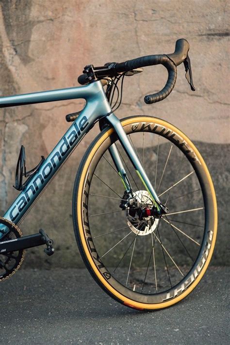 A Blue And Yellow Road Bike Parked In Front Of A Stone Wall With