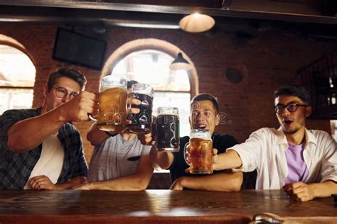 Drinking Beer. People in Casual Clothes Sitting in the Pub Stock Photo ...