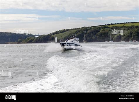 Speedboat Following In The Wake From A Luxury Motor Cruiser Off The