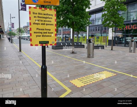 Signs and stickers on pavement to guide pedestrians along ...