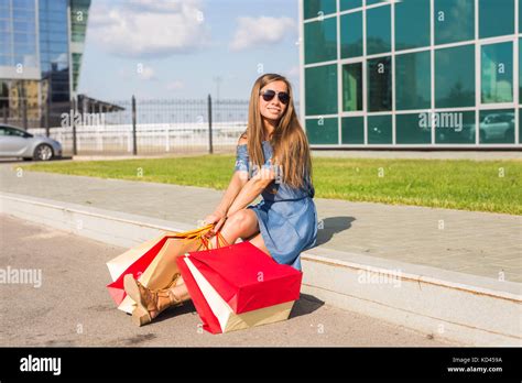 After Day Shopping Close Up Of Young Woman Carrying Shopping Bags While Walking Along The