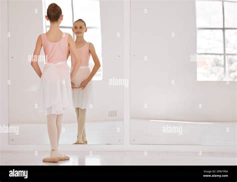 Young ballet dancer dancing in studio, doing dance performance before competition and learning ...