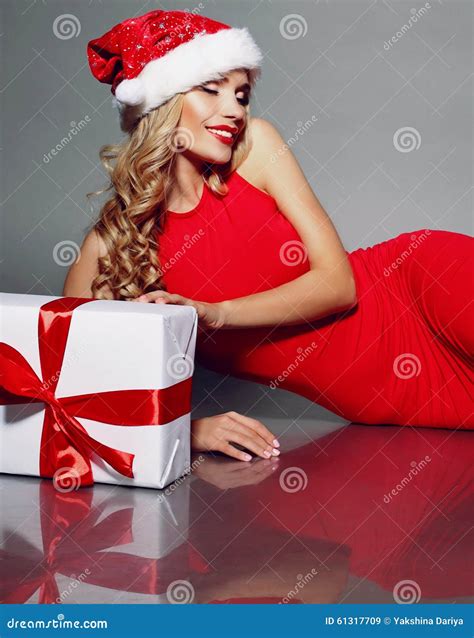 Blonde Santa In A Red Dress Holding Christmas Gift Stock Image Image