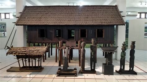 Several Wooden Sculptures Are In Front Of A House