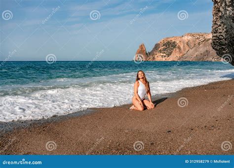 Happy Woman In Bikini Sits On The Sea Beach Tanned Girl Sunbathing On