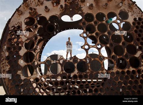 Man Stands Atop An Abandoned Train In Uyuni Stock Photo Alamy