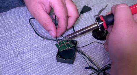 Soldering Iron In A Man S Hand A Man Uses A Soldering Iron To Repair