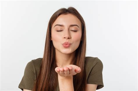 Premium Photo Portrait Of A Young Woman Blowing A Kiss Isolated Over