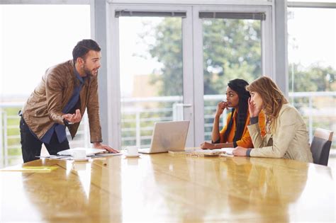 Three People At Business Meeting Stock Photo