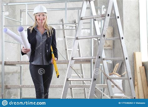 Smiling Woman Architect Or Construction Engineer With Spirit Level Wear