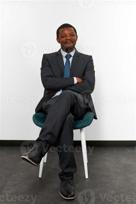 Smiling African American Black Man In Business Suit Sitting On Chair