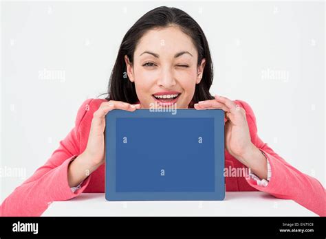 Elegant Brunette Showing Tablet And Winking Stock Photo Alamy