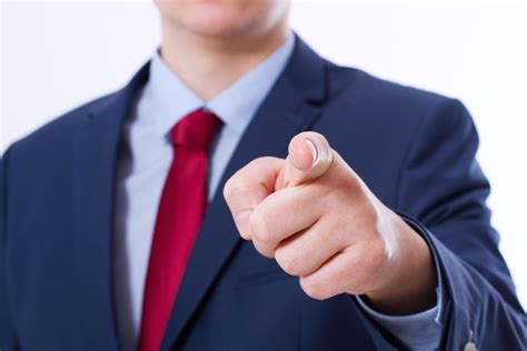 Close Up Of Business Man Pointing Finger On You Isolated On White