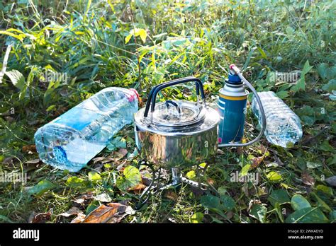 Camping Kettle With Gas Burner And Plastic Water Bottles Stock Photo