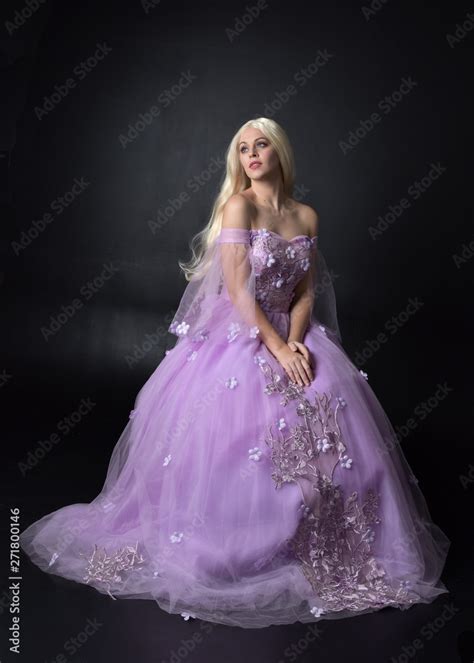 full length portrait of a blonde girl wearing a fantasy fairy inspired costume, long purple ball ...