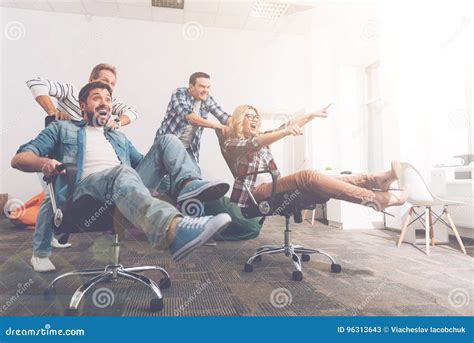 Cheerful Colleagues Having Fun In Office Chairs Stock Image Image Of