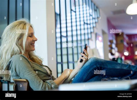 Mature Woman Sitting Legs Up Hi Res Stock Photography And Images Alamy