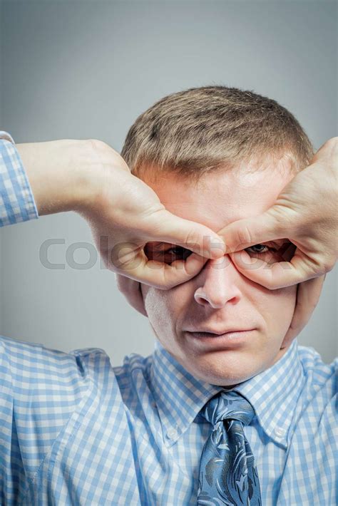 Funny Man With Hand Over Eyes Looking Through Fingers Stock Image