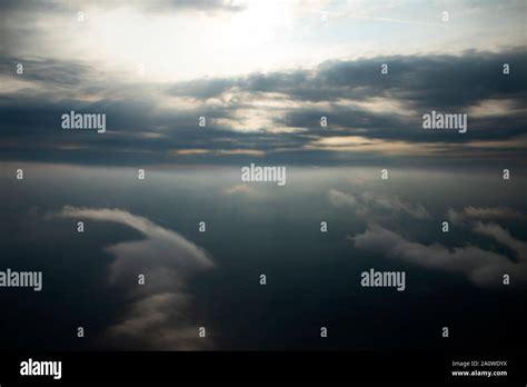 Looking Down Through Dramatic Clouds To Planet Earth Stock Photo Alamy