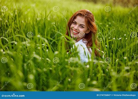 Cheerful Woman Sitting In Grass Looking At Camera Smiling At Camera Stock Image Image Of Dress