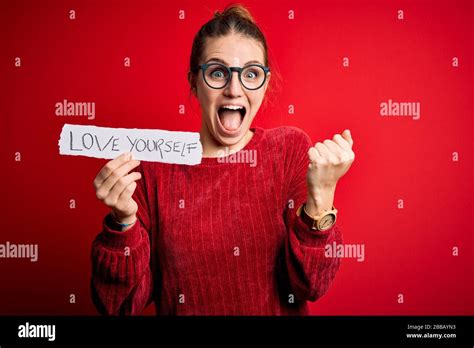 Young Beautiful Redhead Woman Holding Paper With Love Yourself Message Screaming Proud And