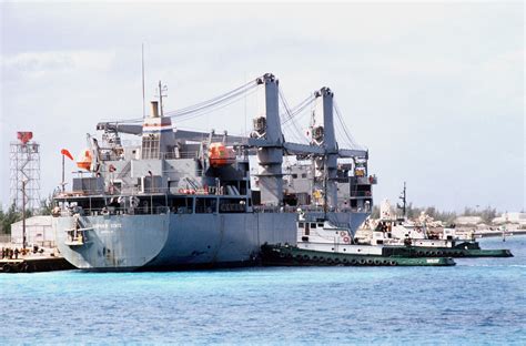 Tug Boats Push The Military Sealift Command Auxiliary Crane Ship GOPHER