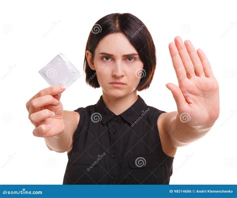 Aware Young Woman Showing A Condom Or Contraceptive Isolated On A White