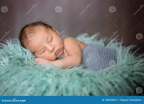 Cute Little Newborn Baby Boy Sleeping In Basket With Wrap Stock Image